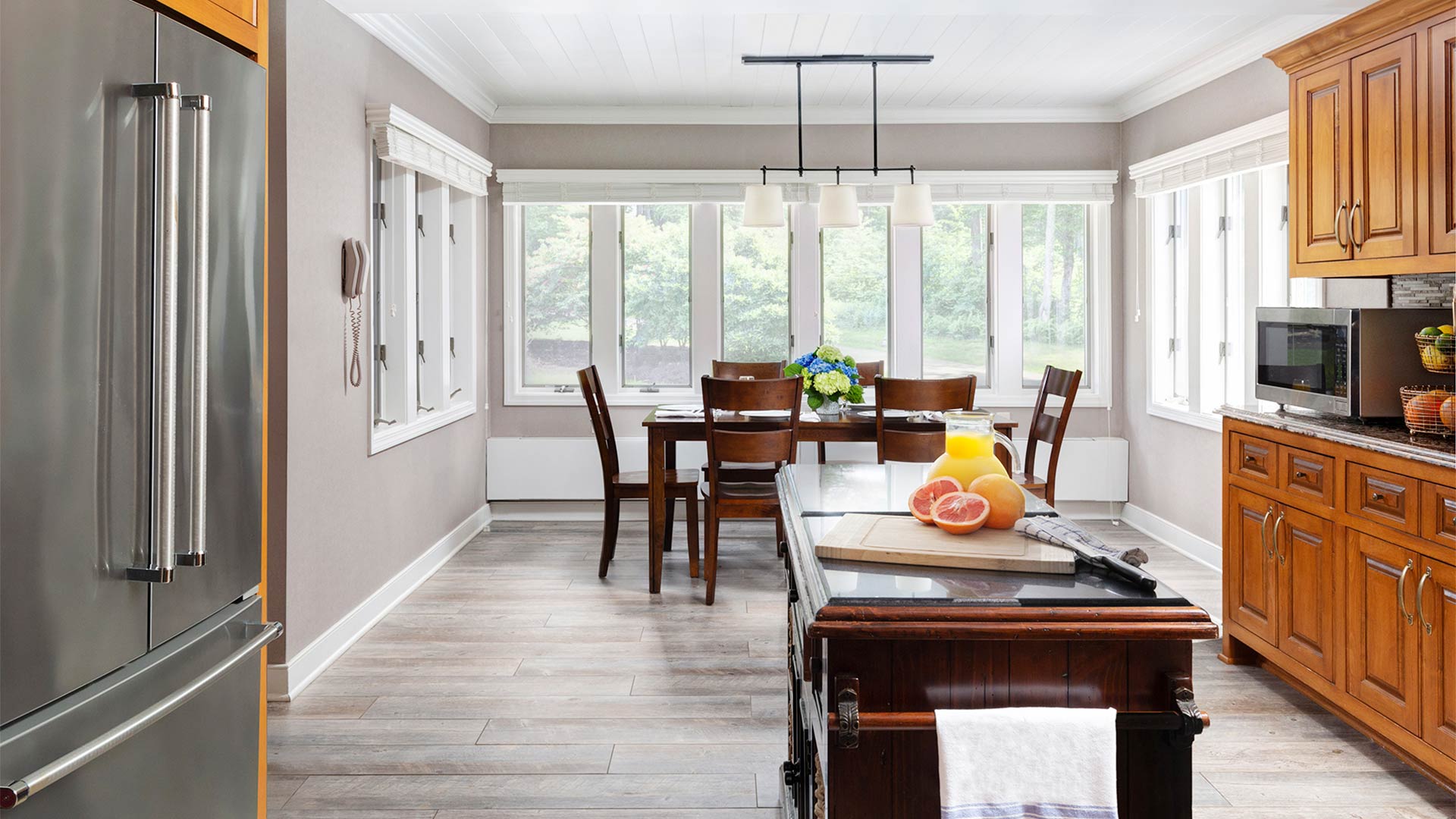 interior shot of the arden kitchen. There are stainless steel appliances and light wood cabinets. There is a small island in the center of the kitchen.