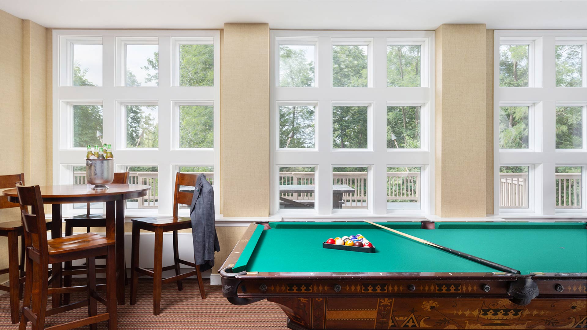 interior shot of a game room with a pool table and a table.