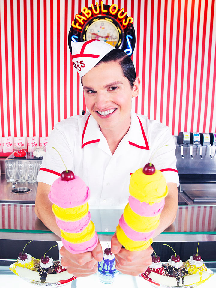 man at ice cream shop serving two ice cream cones
