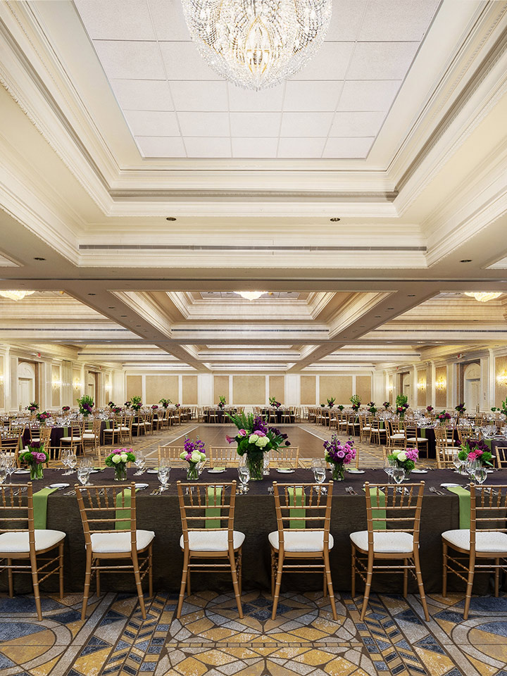 large square room with table and chairs surrounding the perimeter