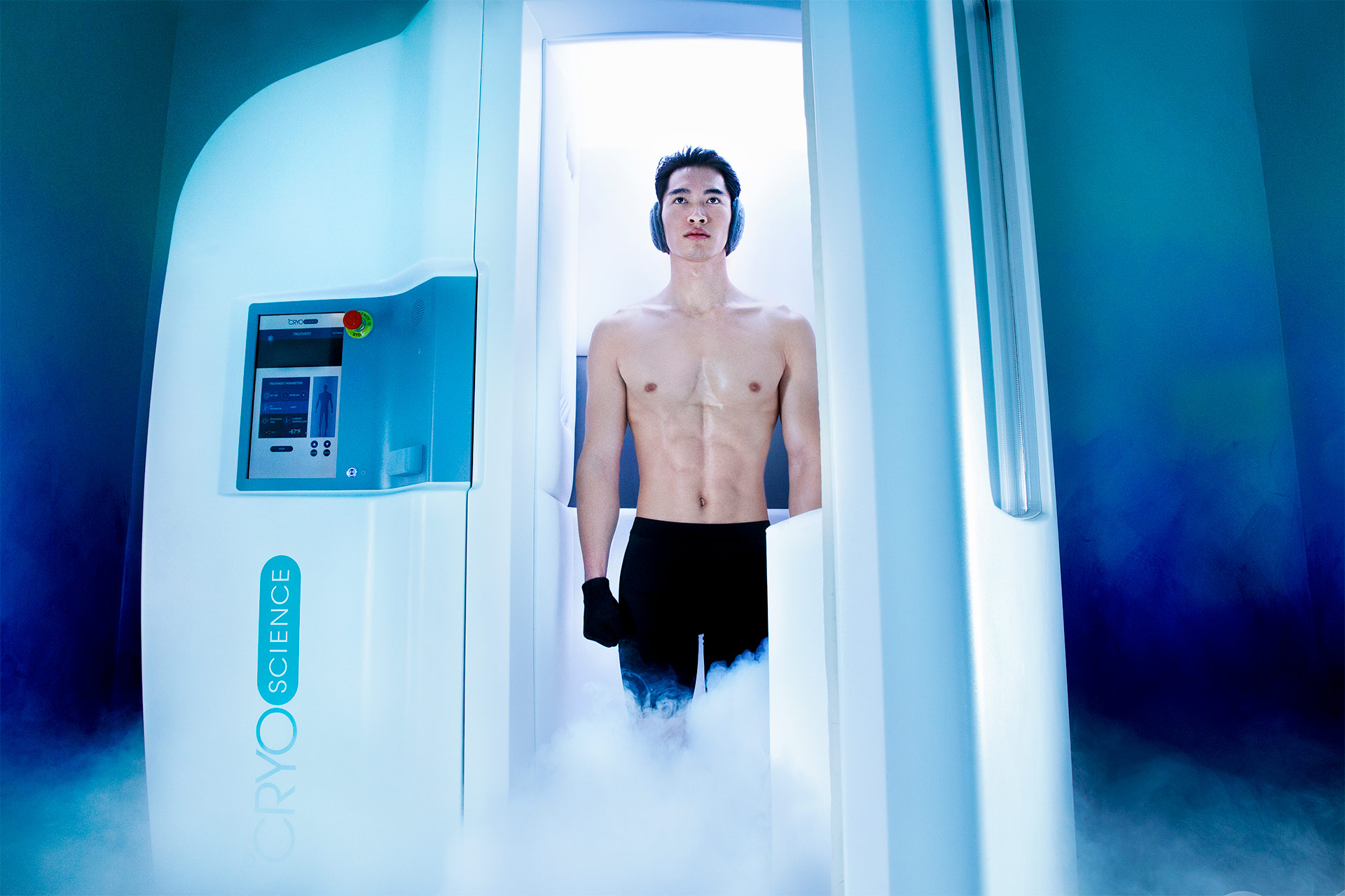 A shirtless man standing inside a white capsule with smoke surrounding