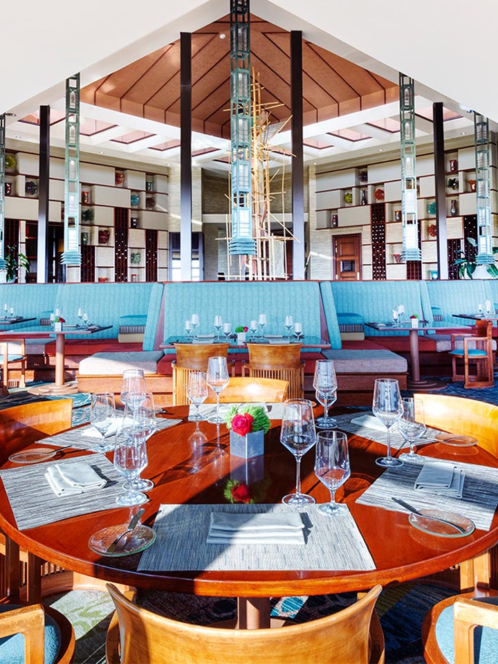 restaurant with blue booth seating and a modern open interior design
