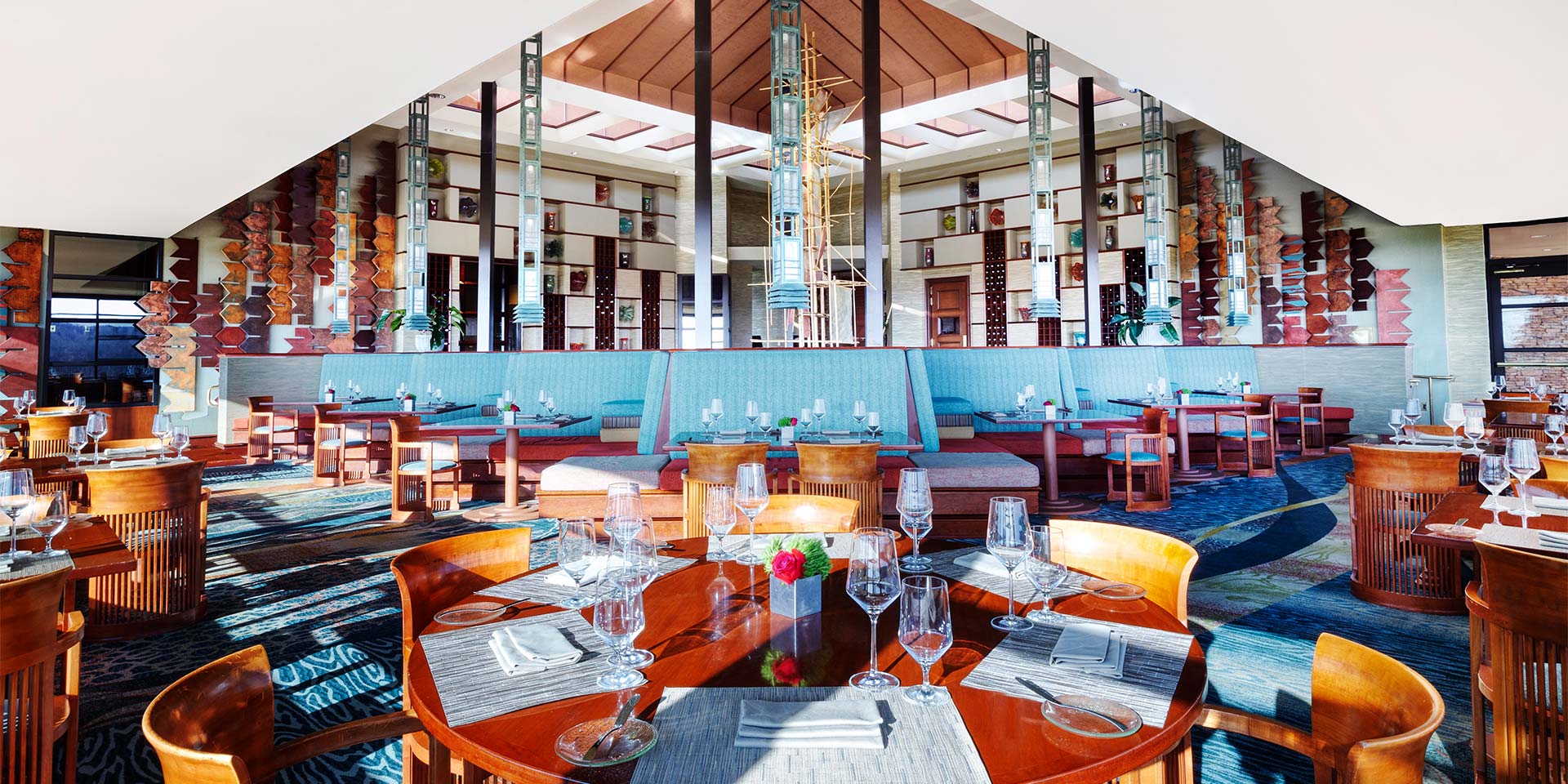 restaurant with blue booth seating and a modern open interior design