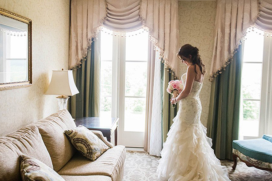 bride holding flowers in a hotel room