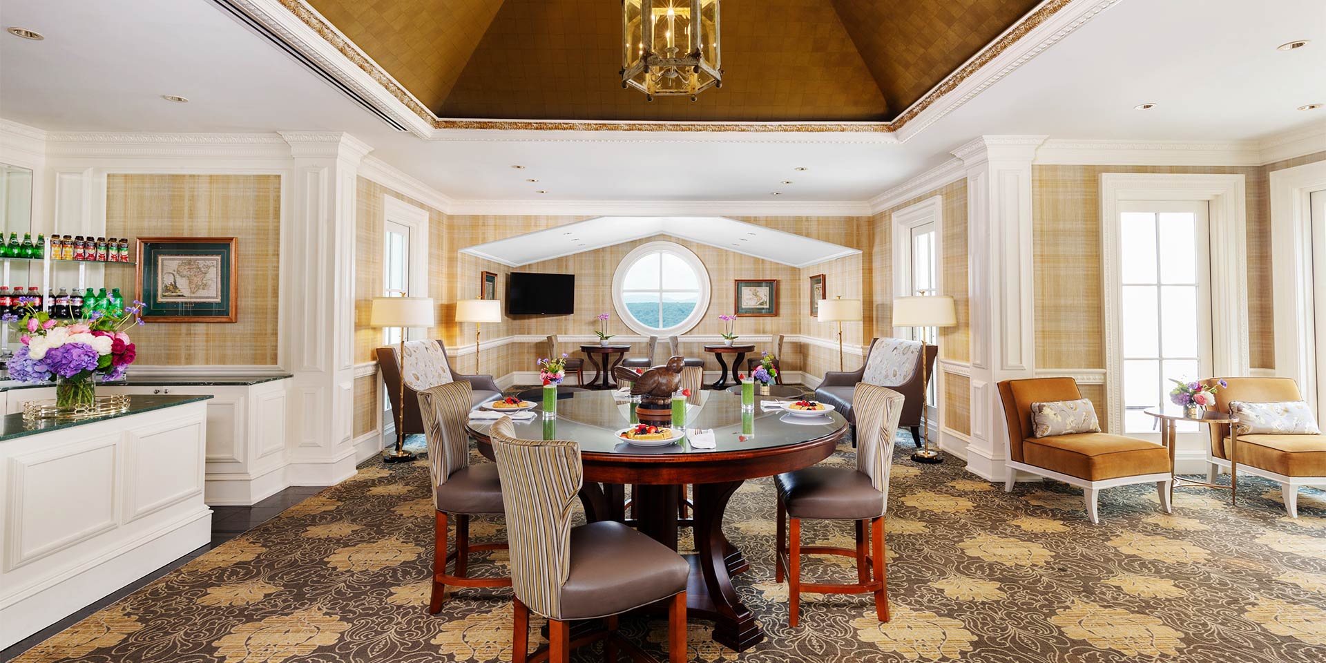 a table is set up with four chair in a dining room.