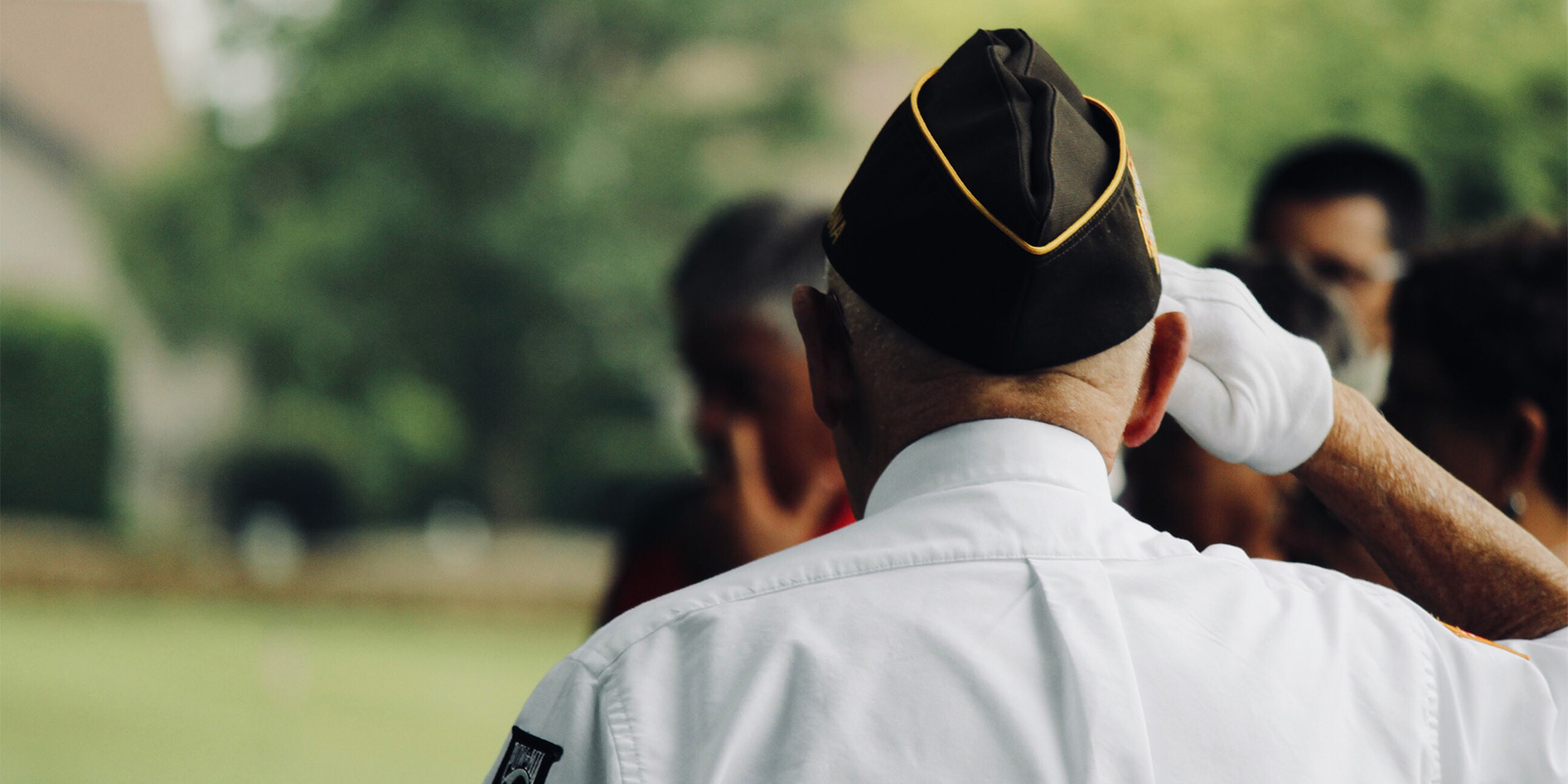 the back of the head of a man in a veteran's cap