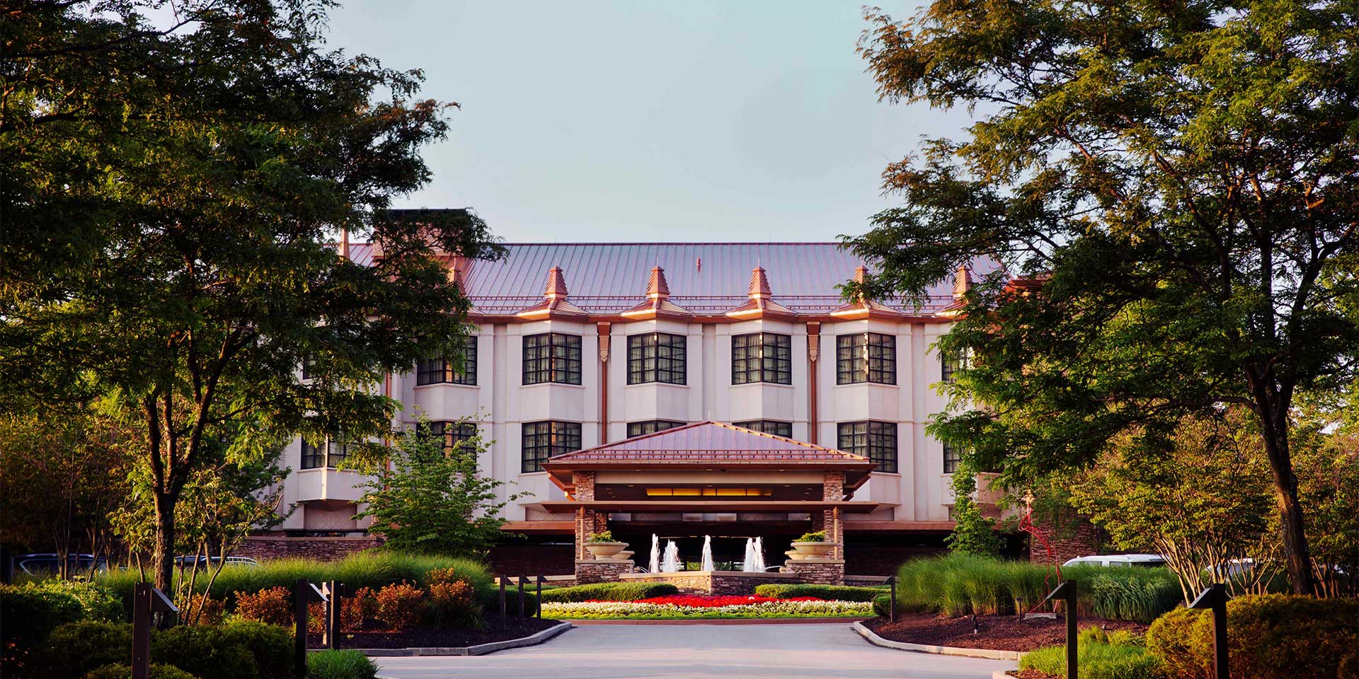 an image of the front of the hotel with fountain