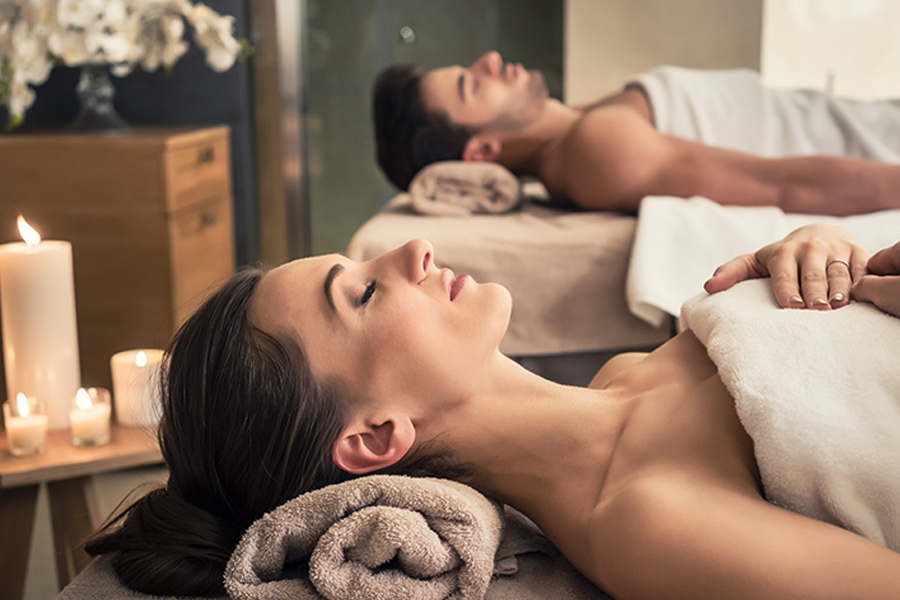 A couple enjoys a soothing and relaxing massage during their spa day.