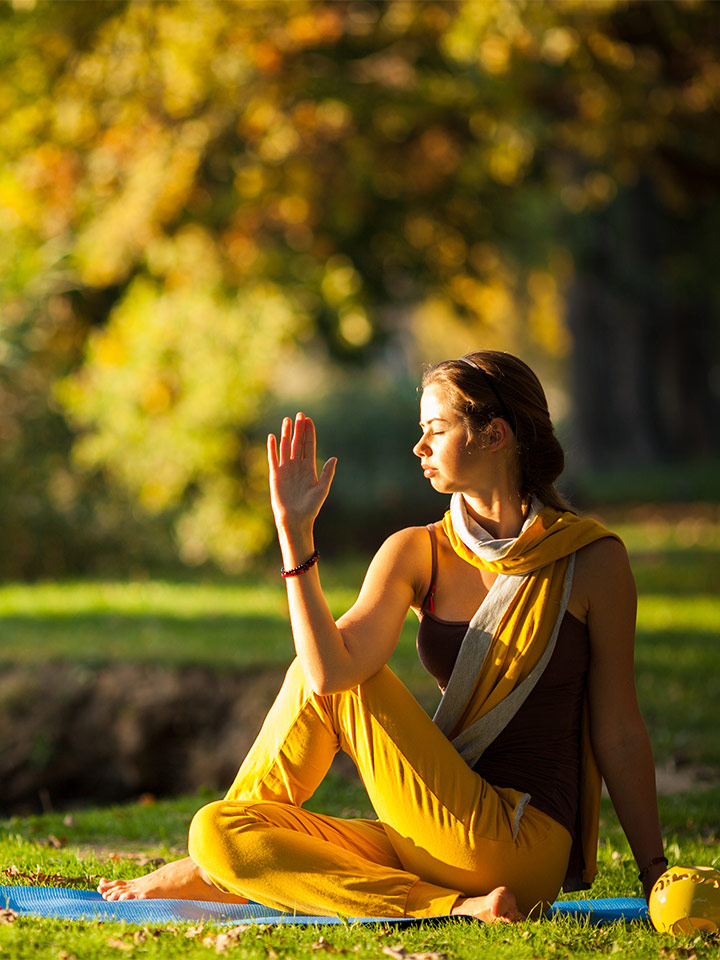 A woman doing yoga in the spring time.