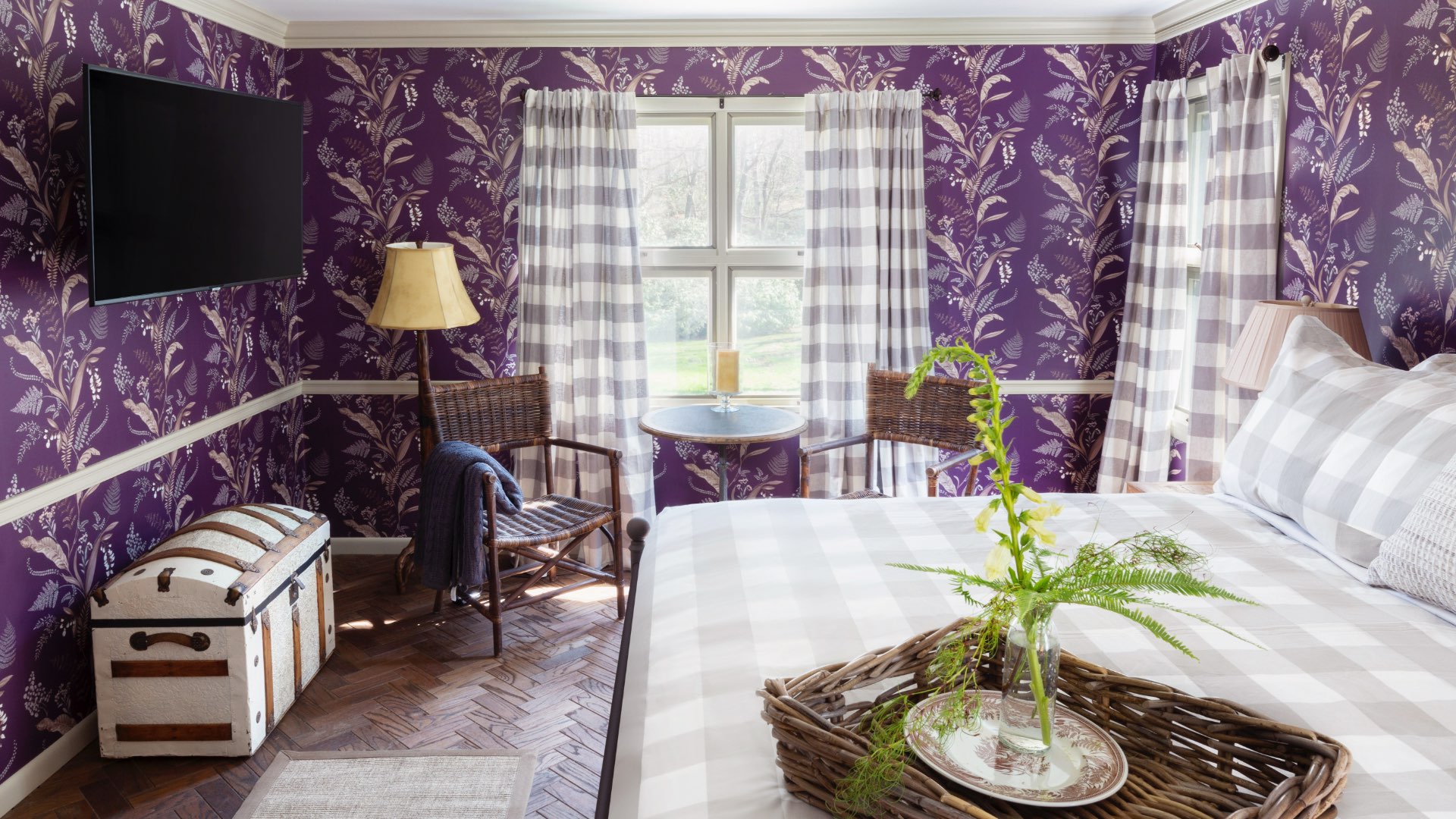 Purple room with bed and trunk