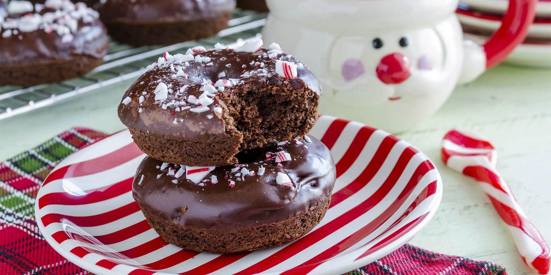 Chocolate donuts with candy cane sprinkles.