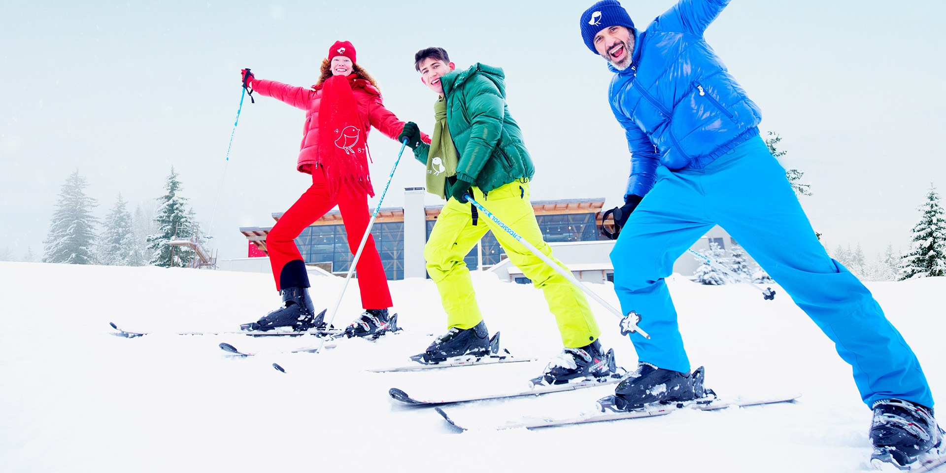 Three skiers in bright colored clothing winter