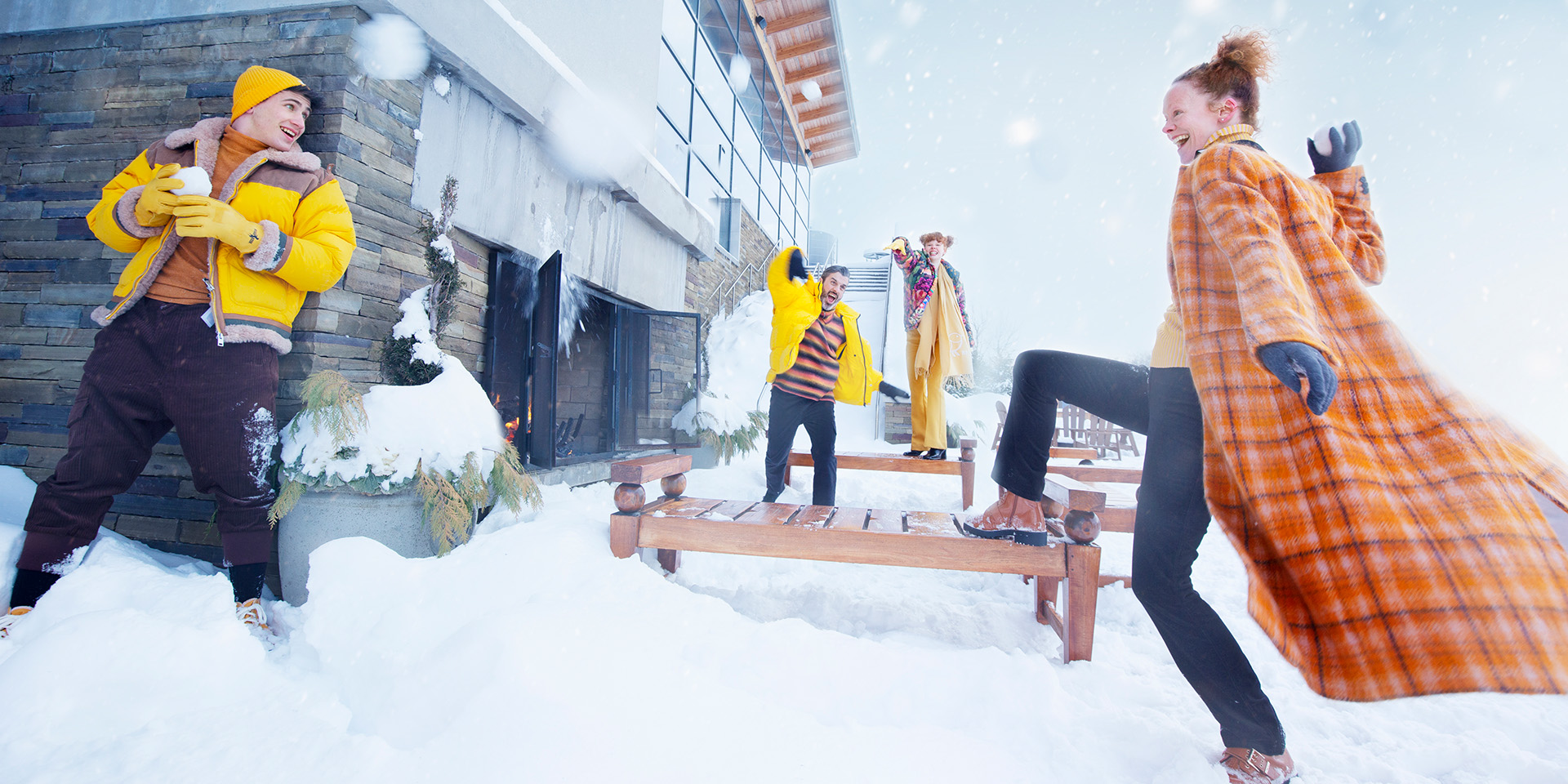 A family throwing snowballs at each other in the winter