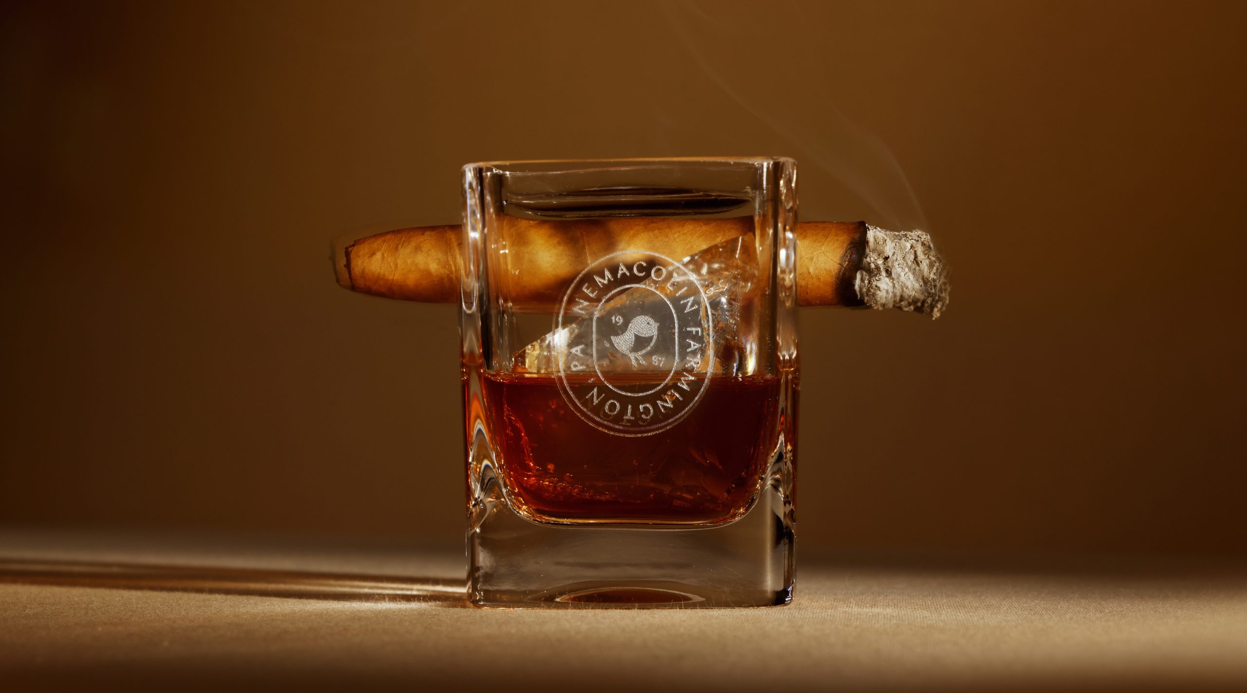 whiskey and cigar glass with logo