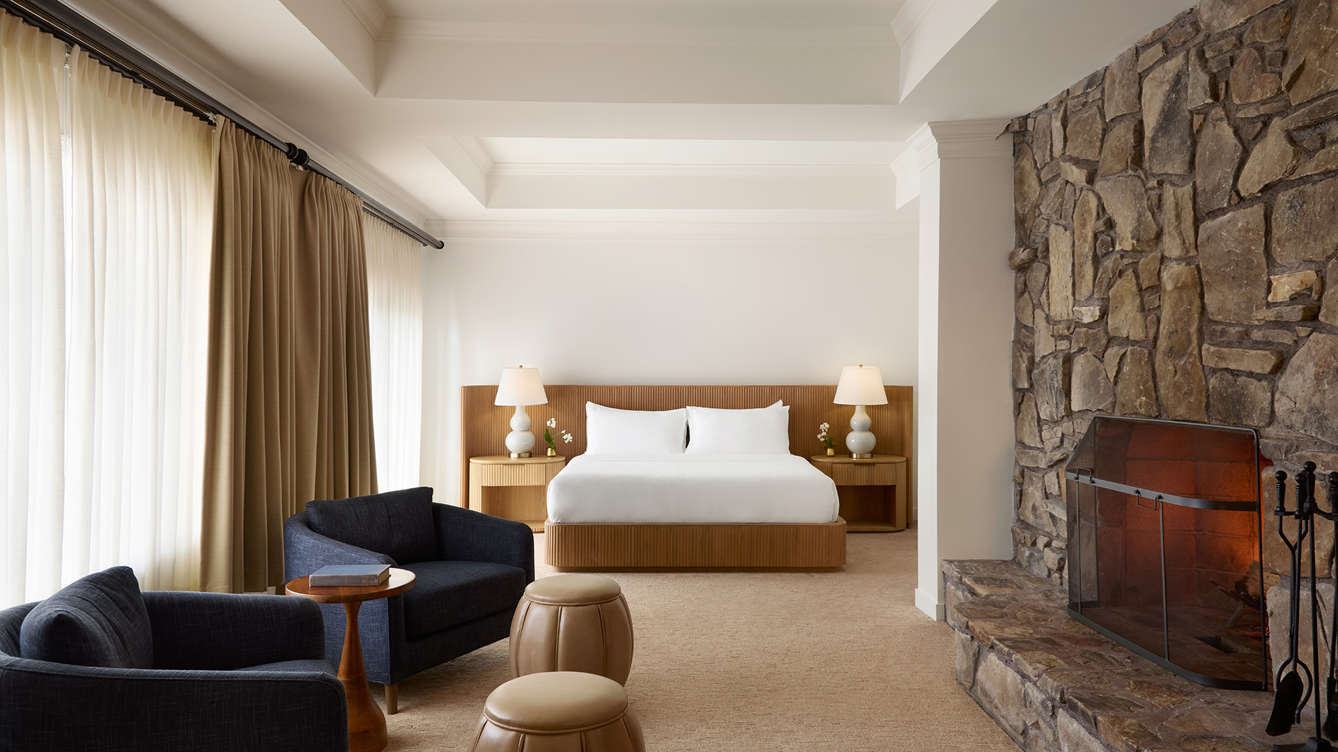 Bedroom with a fire place and seating area