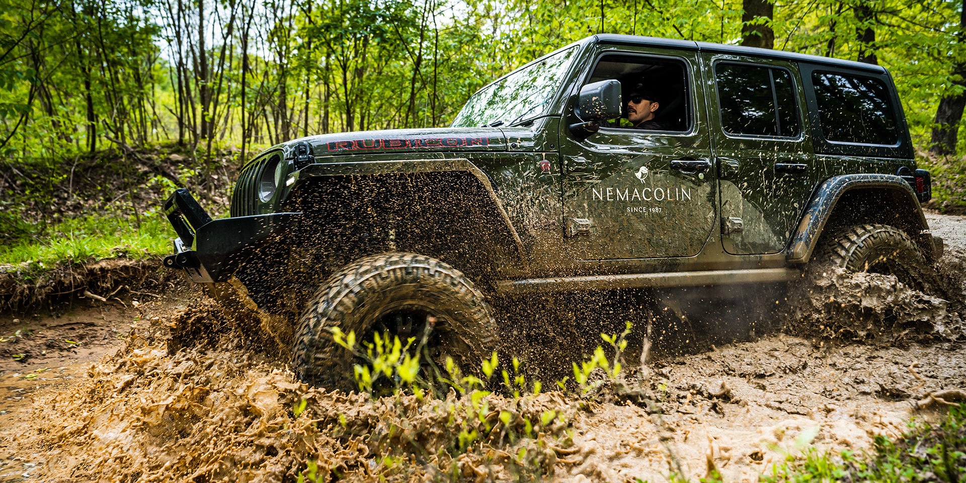 jeep driving through mud