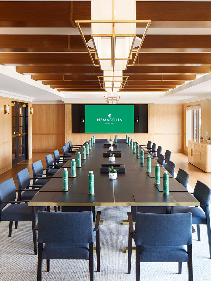 meeting room with a table and chairs facing a tv