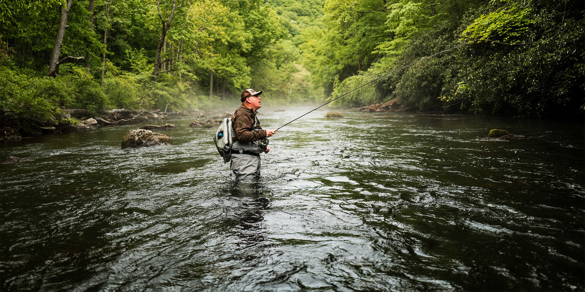 fisherman in a stream