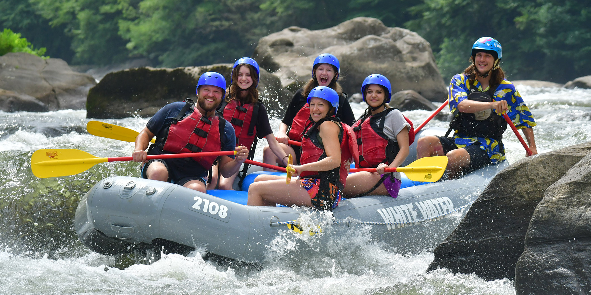 family whitewater rafting on a river