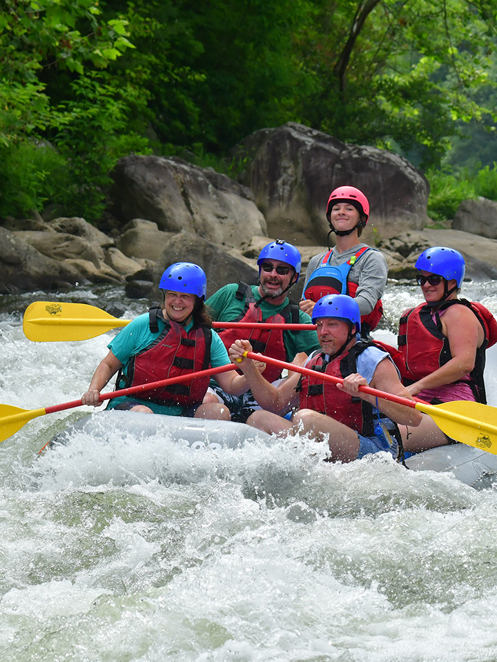 a family rafting on the river