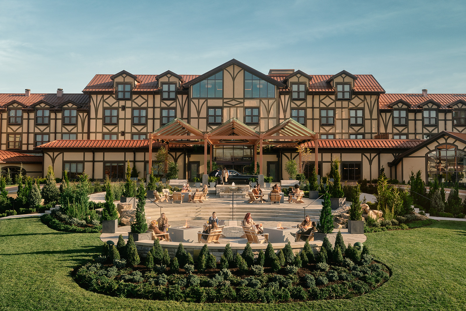 A picturesque view of The Grand Lodge, showcasing its elegant design surrounded by natural landscapes and lush greenery, creating a luxurious yet rustic feel.