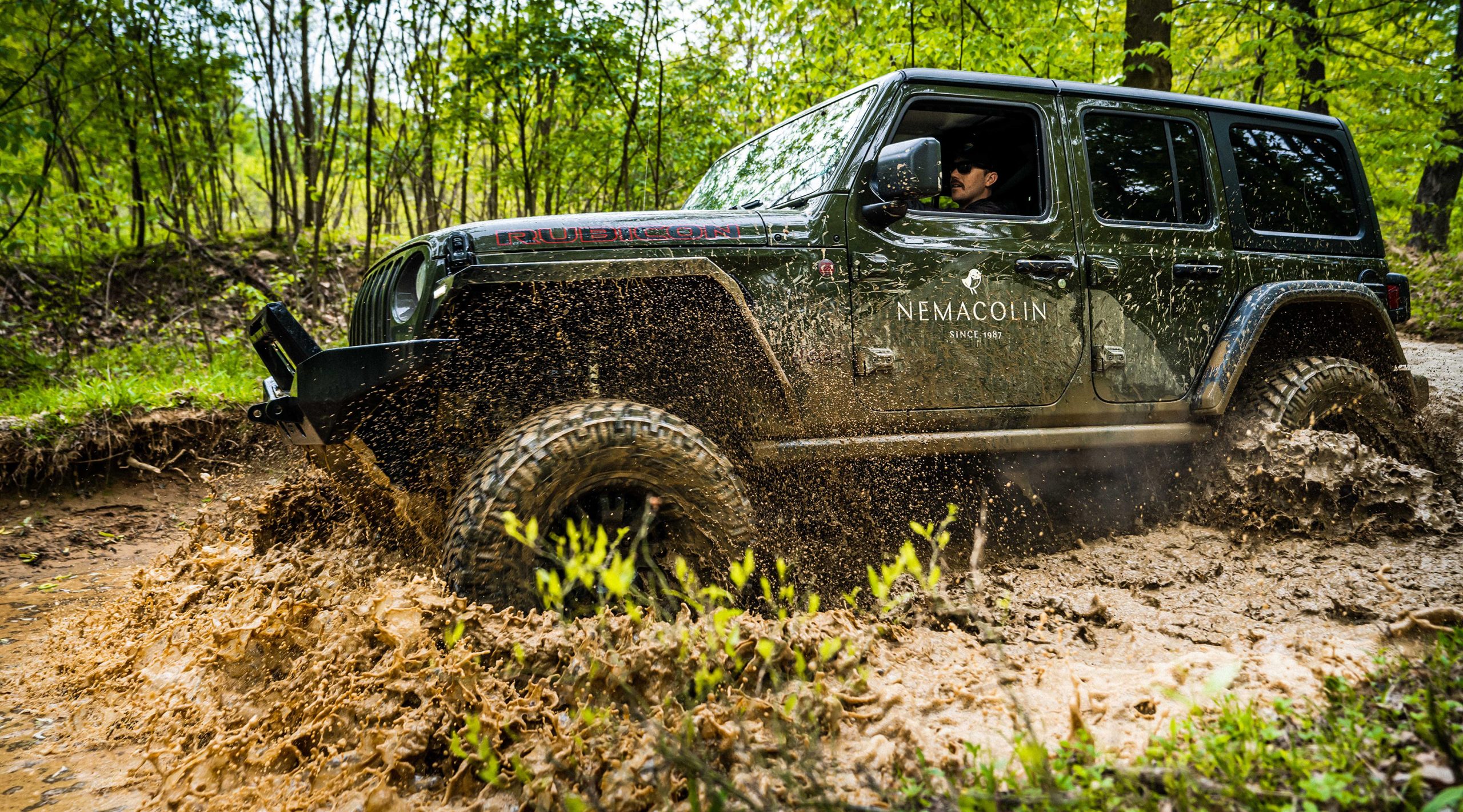 Nemacolin Jeep off-roading on a muddy trail in the woods
