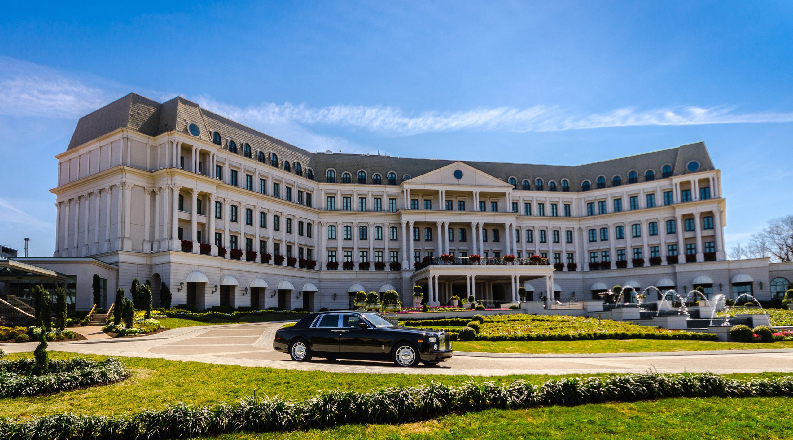 A Rolls Royce drives in front of The Chateau at Nemacolin