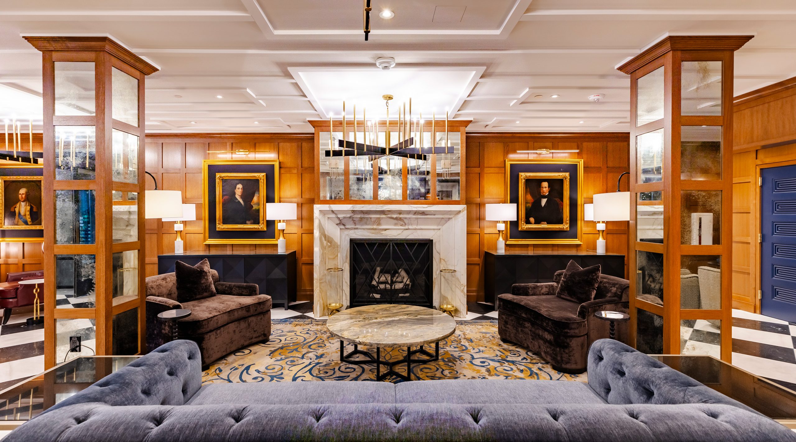 Lobby area outside the Fawn & Fable restaurant at The Grand Lodge at Nemacolin, showing a fireplace and comfortable furniture