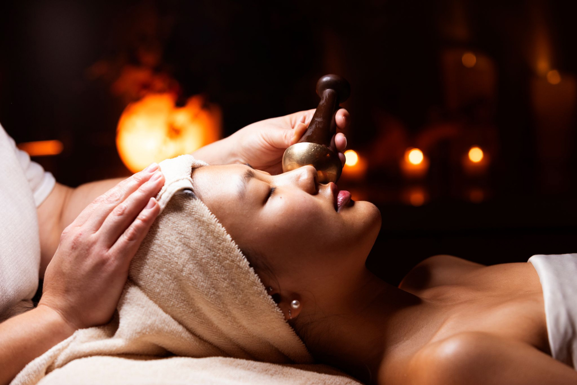 woman laying down on a spa table getting a facial - as part of a gallery decorative page