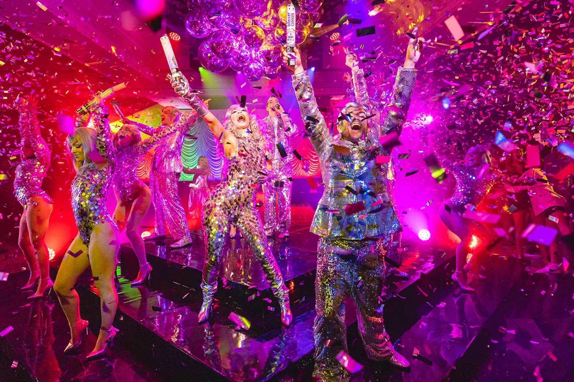 people celebrating in a colorful setting with confetti