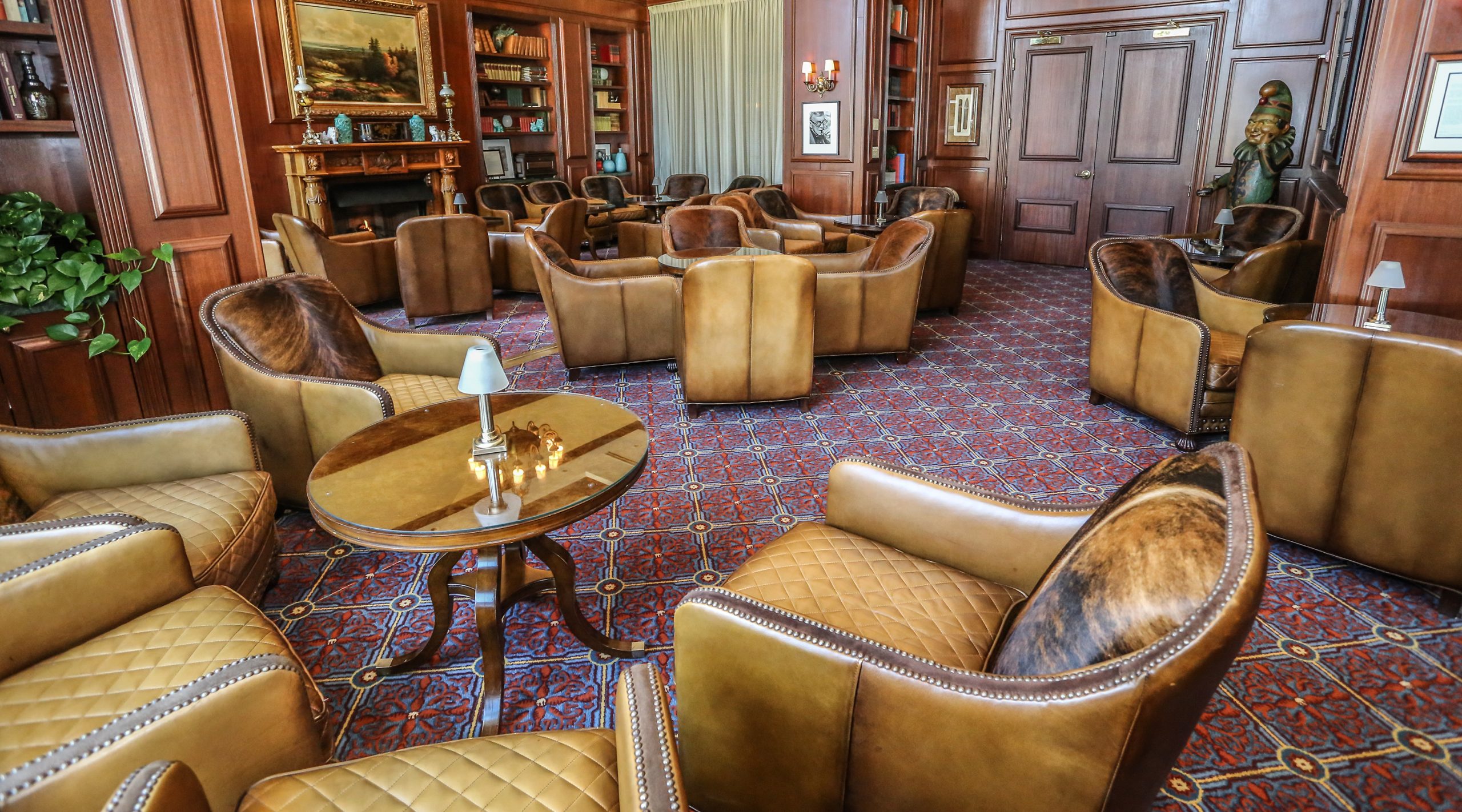 Chairs, tables, and seating inside The Hardy Room cigar lounge at Nemacolin