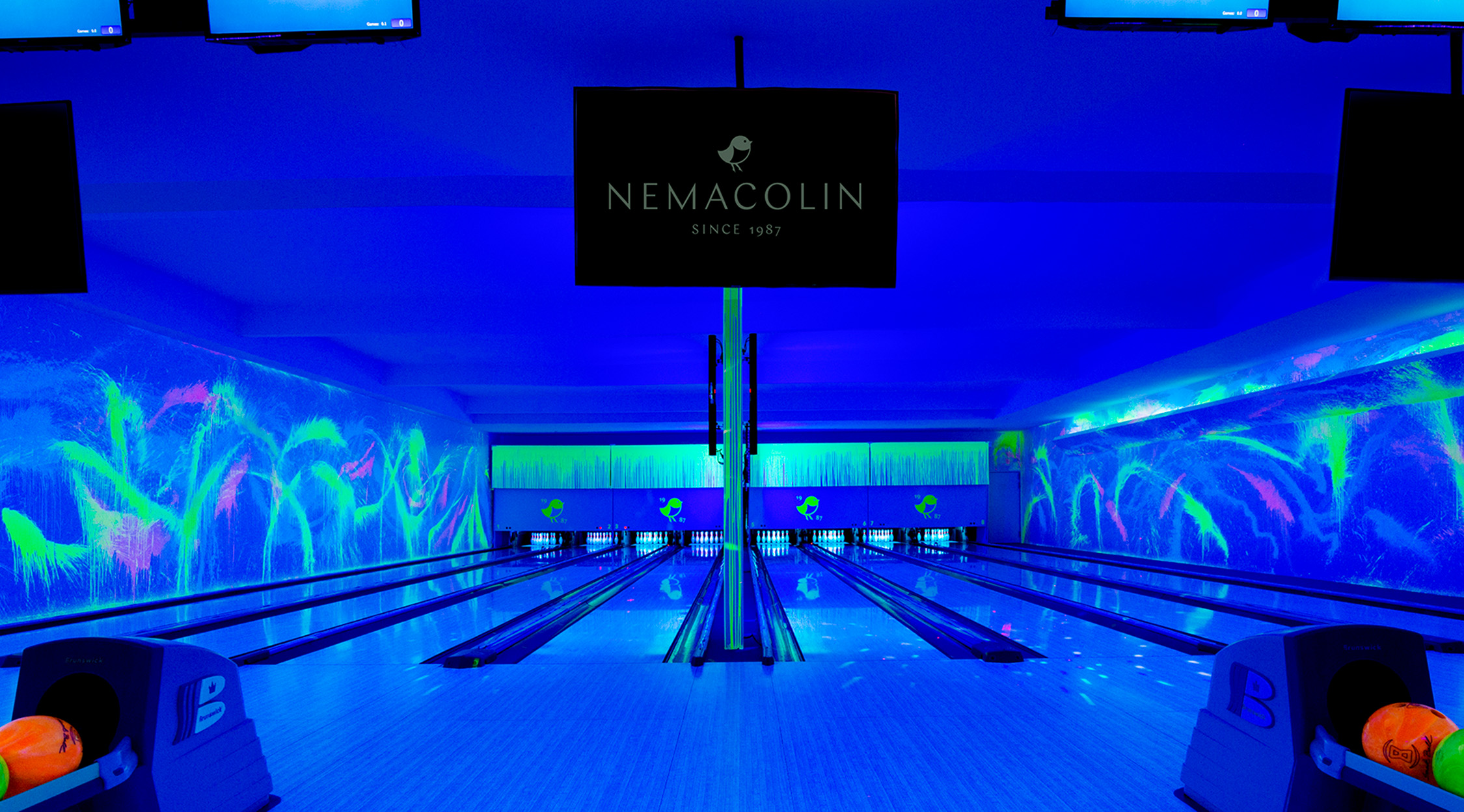 Neon-colored paint and black lights at the cosmic bowling experience at Nemacolin