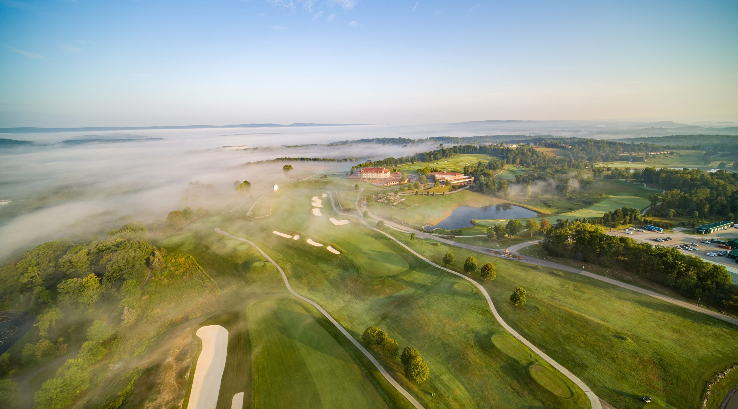 Aerial foggy mountain view of the Falling Rock hotel and golf course at Nemacolin resort