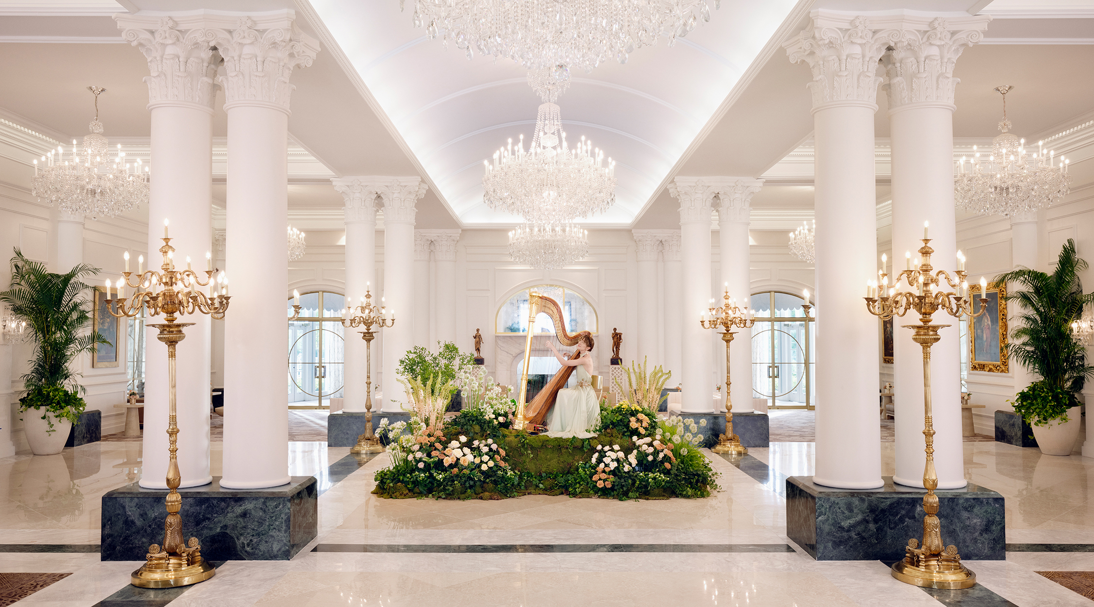 Large columns and crystal chandeliers adorn the lobby of The Chateau at Nemacolin resort