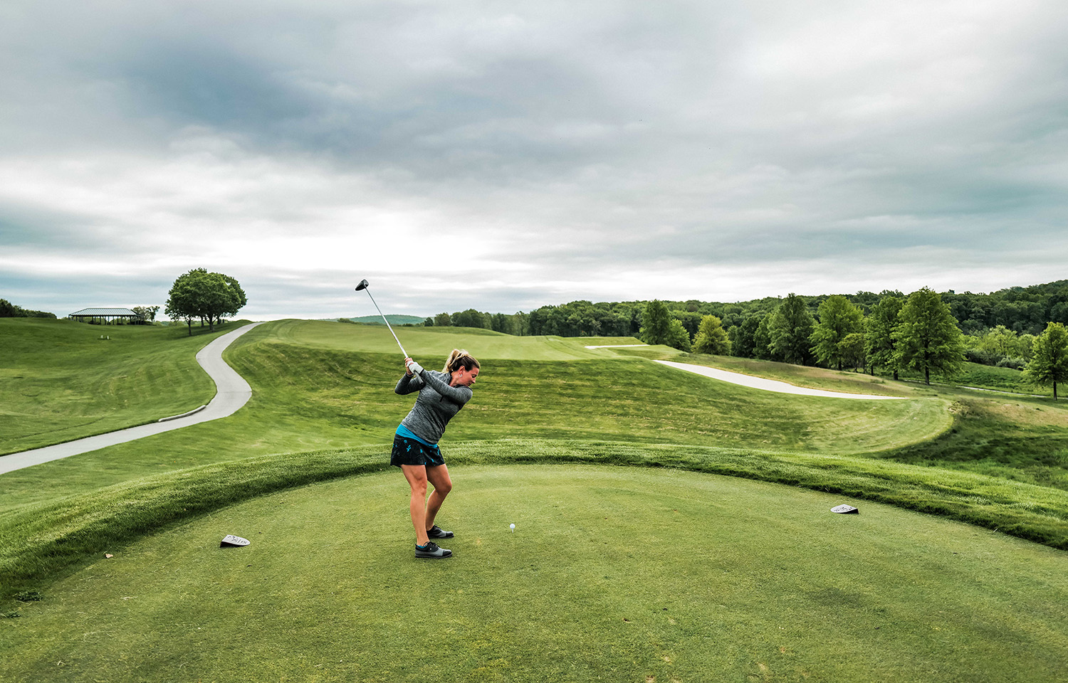 woman hitting golf ball on golf course