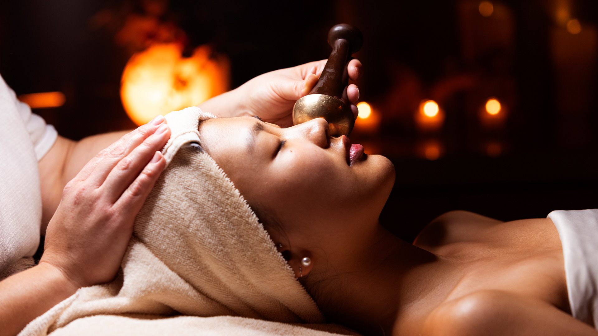 Woman receiving a rejuvenating facial treatment at the Woodlands Spa at Nemacolin.