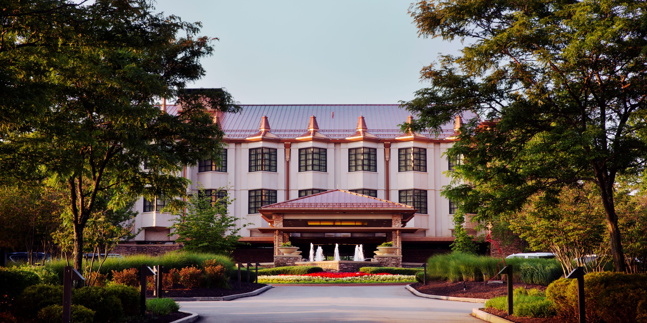 hotel front with flowers and trees