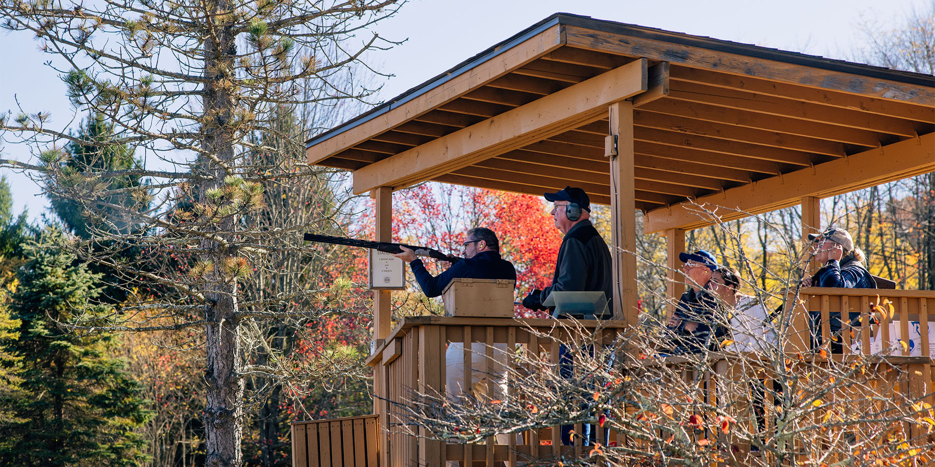 man shooting clays our of a wooden stand at a rod and gun club