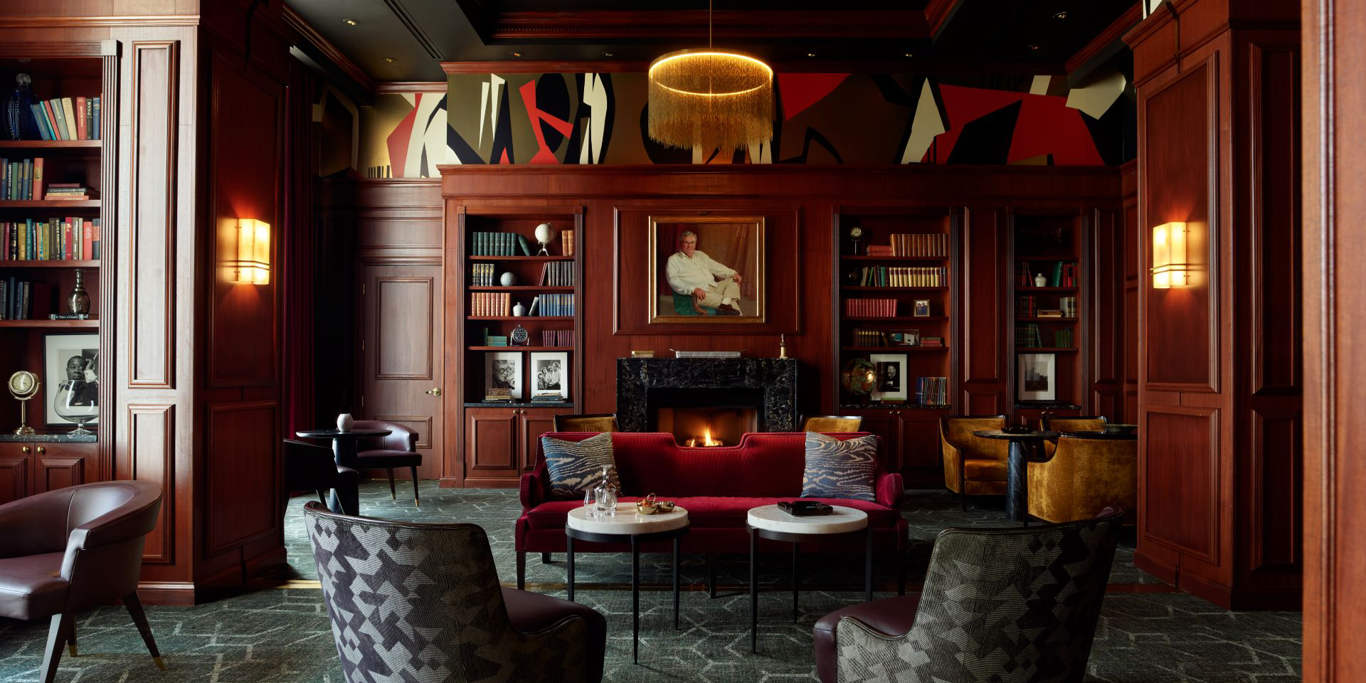 wood panel lounge/bar with books and fireplace